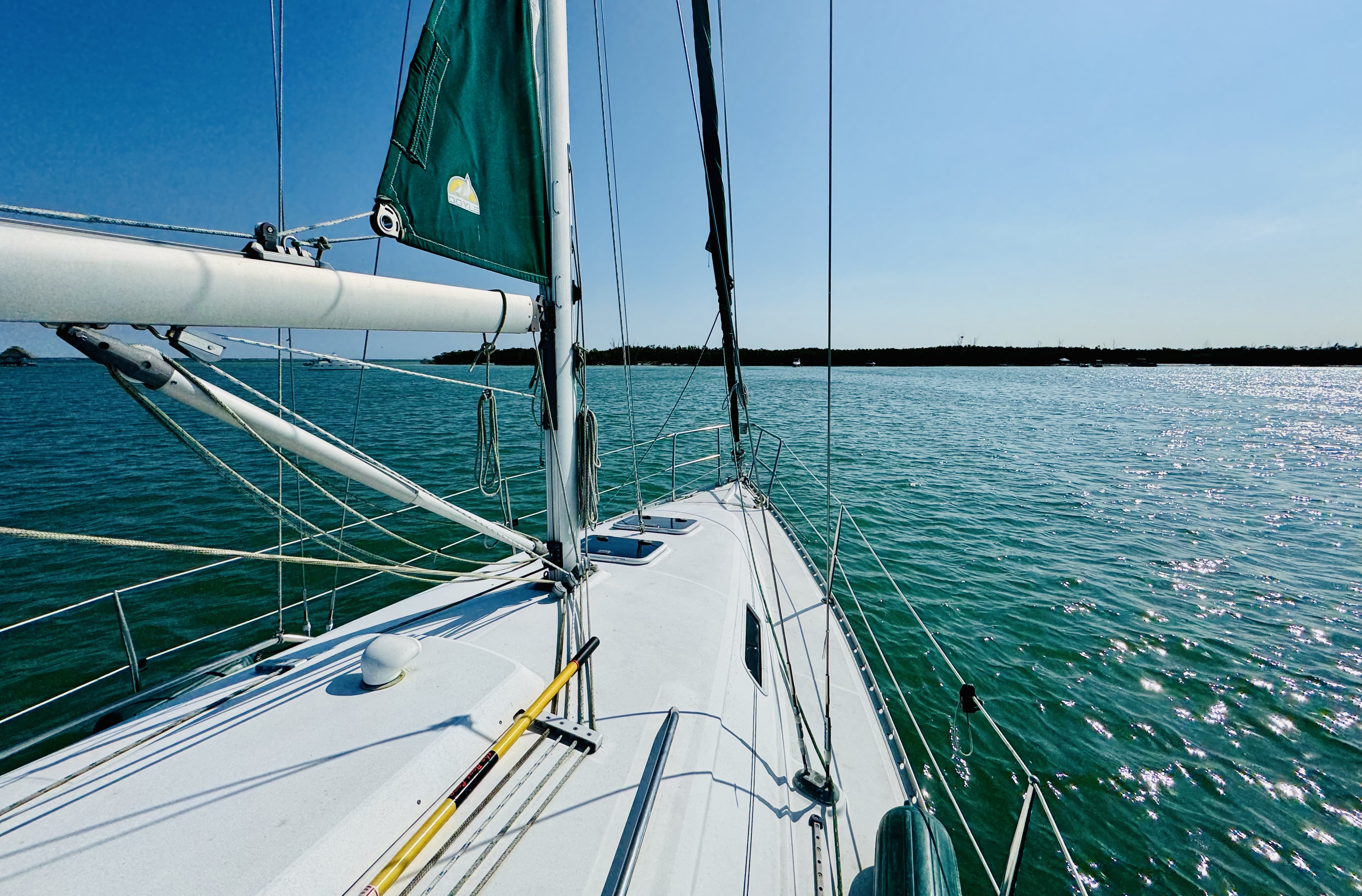 Northern Lights with furled sails at peaceful anchorage